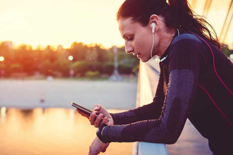 woman on bridge with mobile